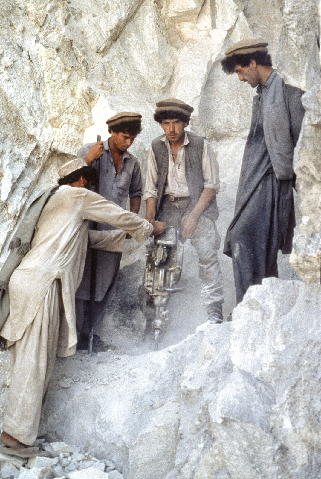 Afghan miners drilling the limestone for rubies at Jegdalek, Afghanistan. (Photo: Gary Bowersox)