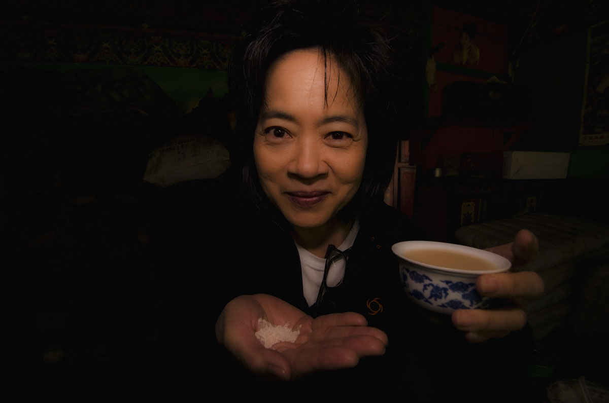 Do you want some tea, grandpa? Wimon Manorotkul enjoying a bit of Tibetan hospitality in Dhongtso 5 (Zha Lin) village. Tsampa (roasted barley flour) and Tibetan tea make for a delicious snack. Photo: Richard W. Hughes