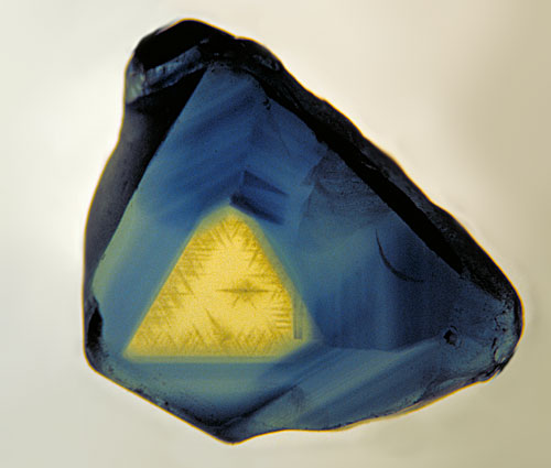 Figure 6.  Outer triangulation… A thin polished slice of an Australian sapphire, looking parallel to the c-axis (parallel to the prism faces. The three-fold symmetry is clearly visible. Photo © Richard W. Hughes