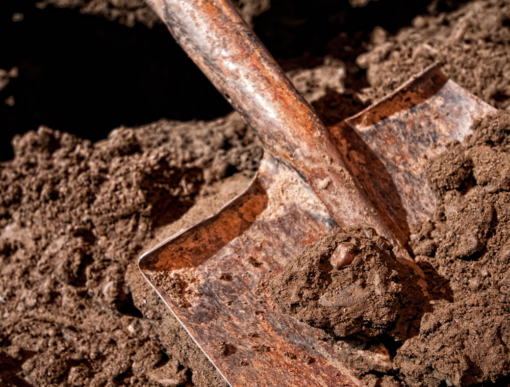 Figure 10. A mud-covered piece of andesine lies in a shovel in Lower Yu Lin Gu valley, near Zha Lin village. Photo: Richard W. Hughes