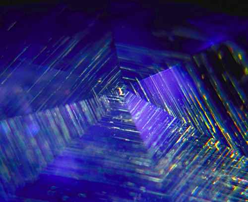 Figure 3. Gossamer… A rutile silk spider’s web spun beneath the facets of an untreated Sri Lankan sapphire. Photo: Richard W. Hughes