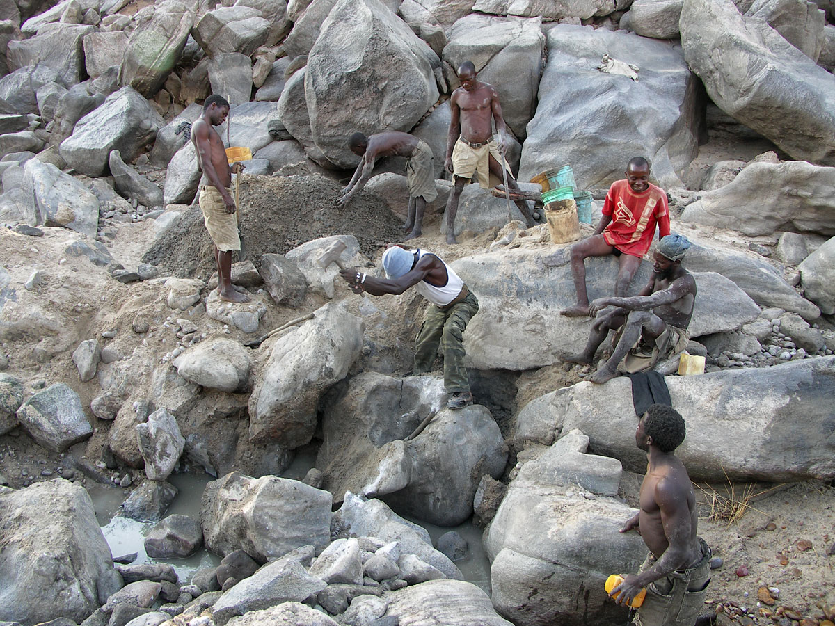 Miners work the dry riverbed at the Muhuwesi river in Tanzania's Tunduru district.