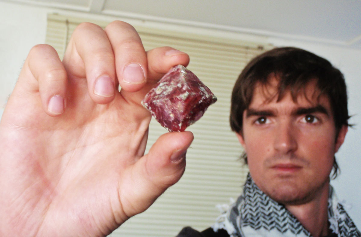 Philippe Brunot holding a spinel crystal from Mahenge. Photo © Guillaume Soubiraa