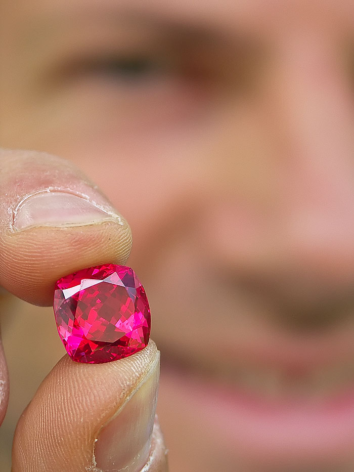 Eric Saul displays a spectacular red Mahenge spinel, cut from one of the large crystals found in the summer of 2007