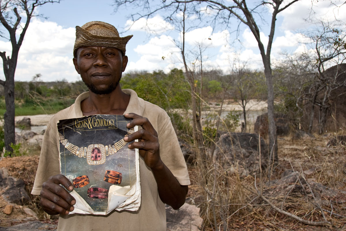 Miner Joseph Mayunga displays one of his prize posessions, a Gems & Gemology magazine that covers the gems of TanzaniaMiner Joseph Mayunga displays one of his prize possessions, a Gems & Gemology magazine that includes an article on the gems of Tanzania, given to him by a Sri Lankan dealer after a successful chrysoberyl deal. At the time of our visit in October, 2007, Joseph had been living and mining at the Muhuwesi river for more than seven years. Photo: Richard W. Hughes, Lotus Gemology.