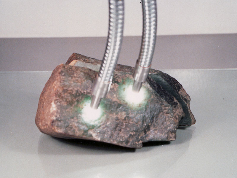 Figure 35. This jadeite boulder had a hole drilled in it from one side to just beneath the surface on the opposite side. A green glue was placed inside near the surface, with a wooden rod added. Then the drill hole was carefully concealed to hide the evidence. Thus when a strong light was shone onto the boulder's surface, a rich green color was revealed. Photos: Richard W. Hughes