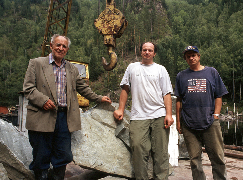 Mikhail "Misha" Khrolenko (center) and his father Yakov Borisovich(left) and brother Sergei (right), owners of the Khakassia jade mines. They are standing in front of a huge chunk of Khakassia jadeite