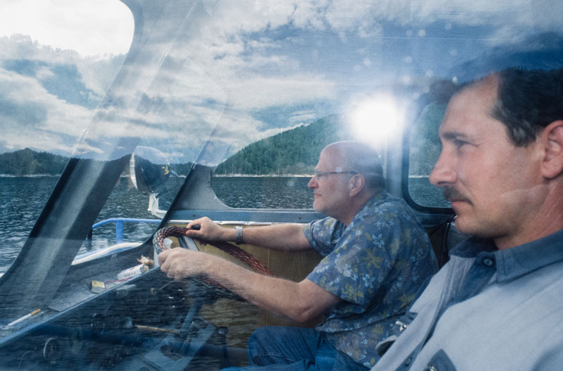 The author getting down to serious business – piloting a boat on the Yenisey River, near the Khakassia jade mines.