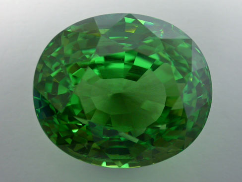 If large clean tsavorites are rare, this gem weighting more than 40 carats is truly an exceptional stone. Believed to have been found at the Karo mine in Merelani, Tanzania, the stone's only visible inclusions using the microscope are the growth lines we can see near the center of this incredible gem.  Stone courtesy Multicolour.com; Photo: V. Pardieu/AIGS, 2004.